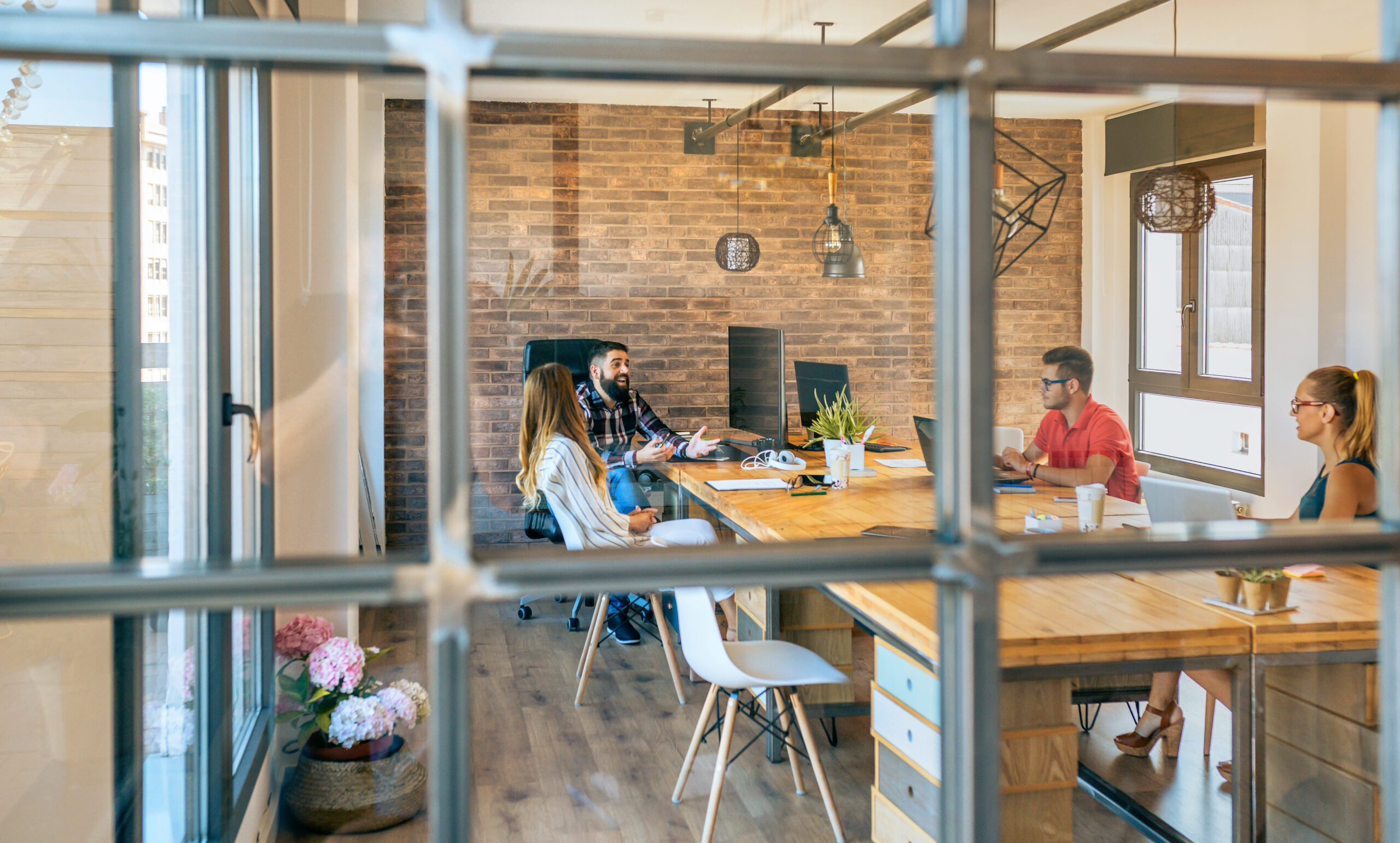 Employees in small startup office in London.