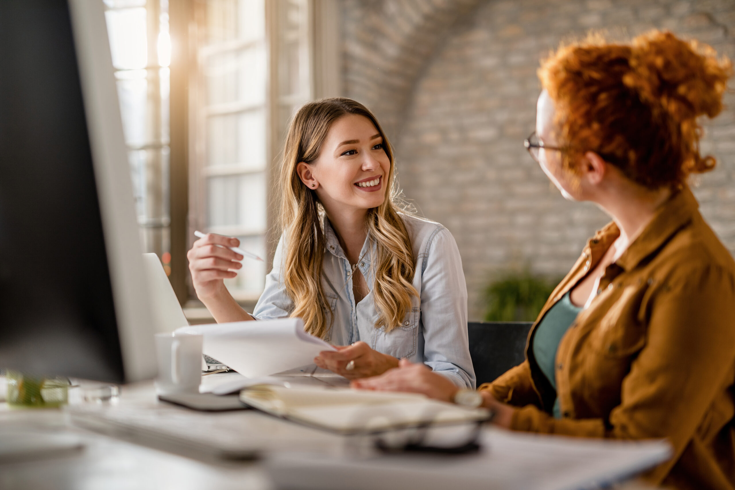 Boss going through positive feedback with employee.