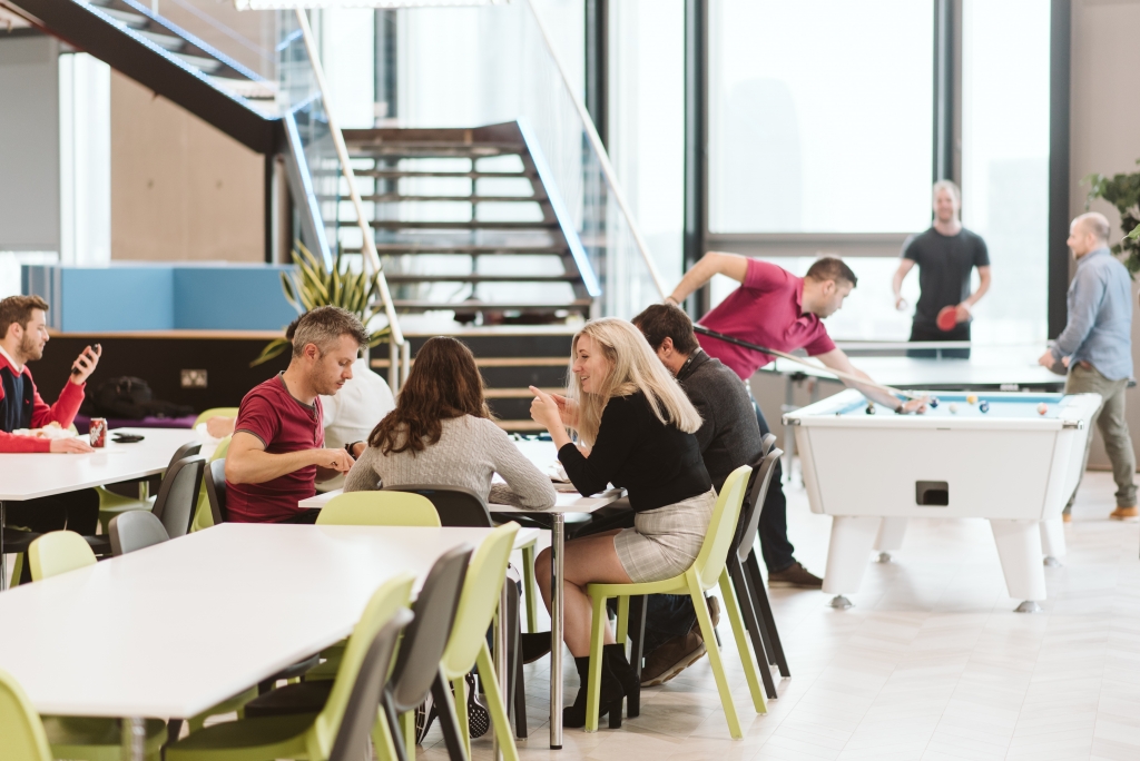 Office breakout area full of employees