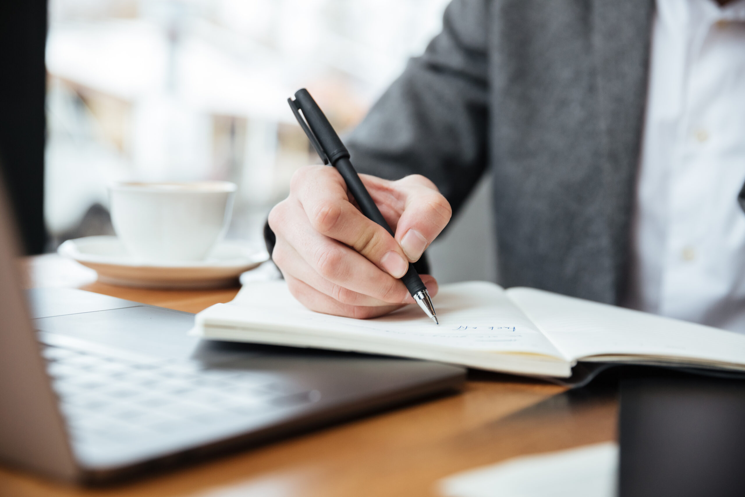 Image of business man sitting by table in cafe