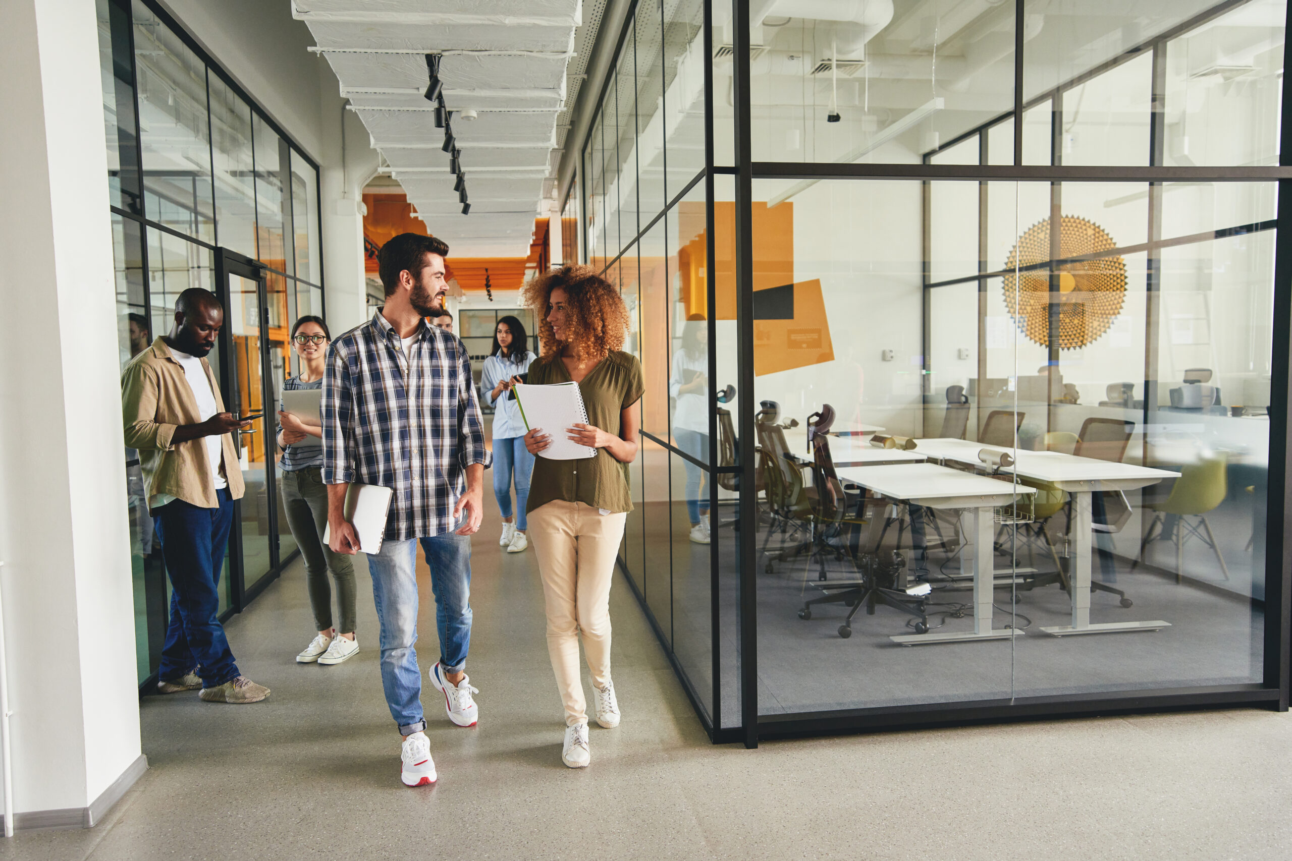 Smiling employees in office space together