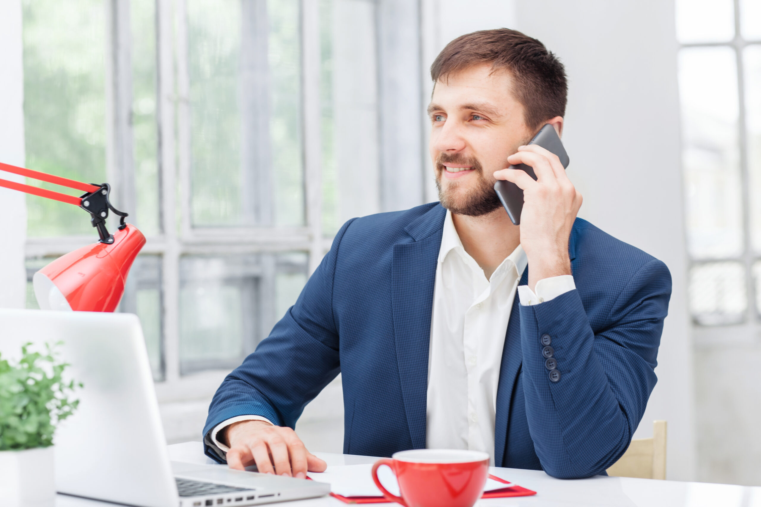 Portrait of businessman talking on phone in office