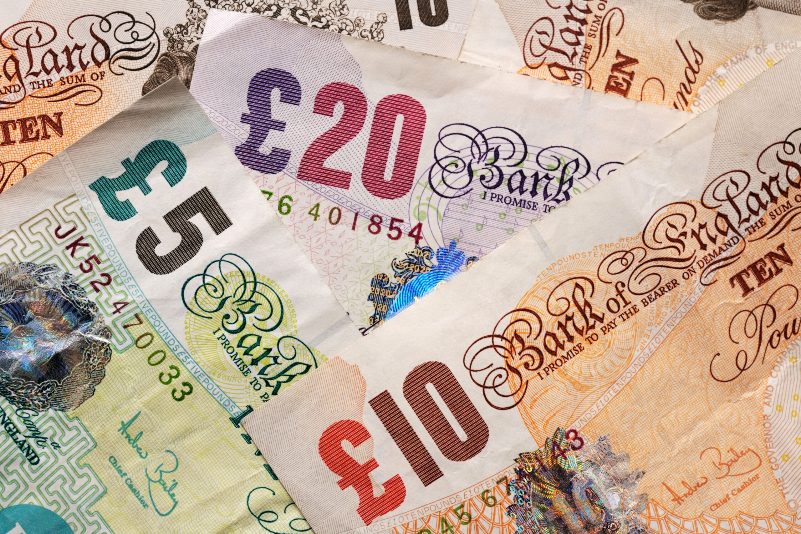Different pound notes in a pile