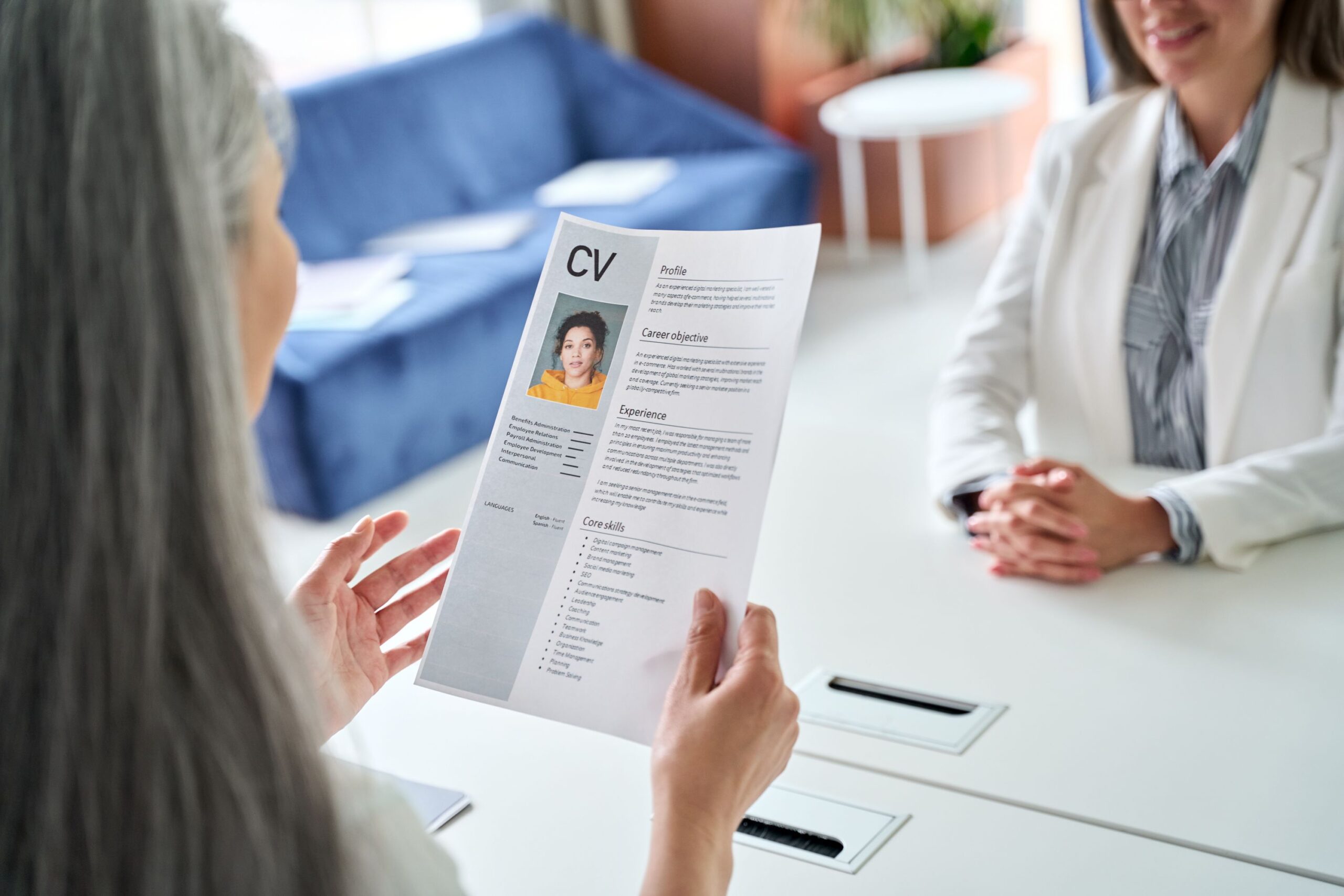 Employer reading candidate's CV in job interview