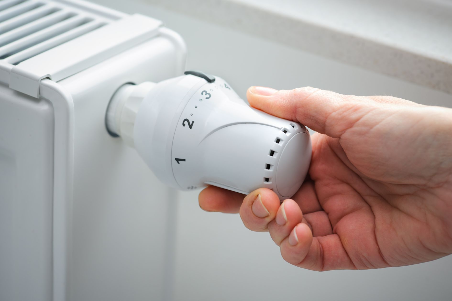 Office employee turning up radiator